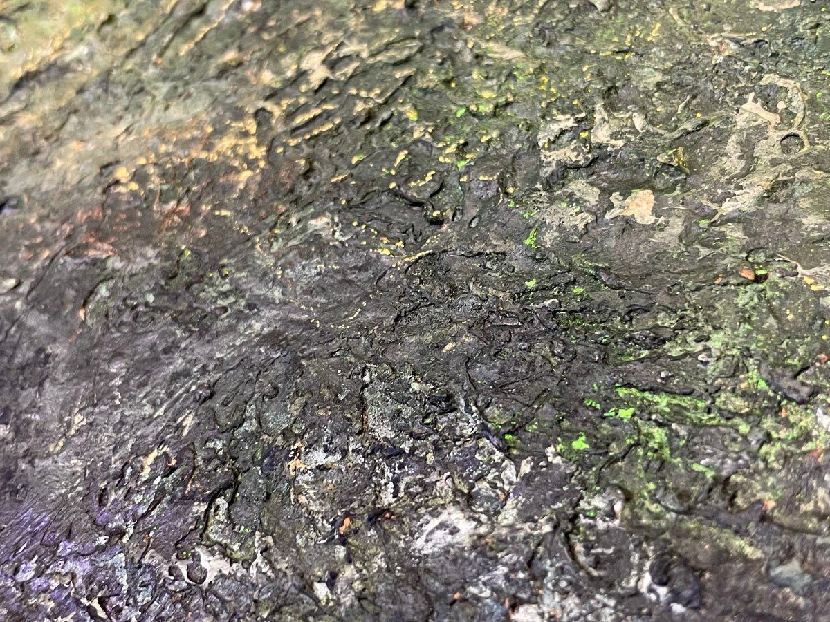 Close-up of a textured surface with green and brown colors