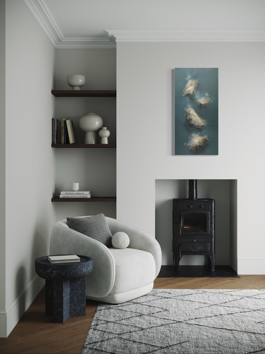 Modern living room with a white armchair, black side table, and wall art.